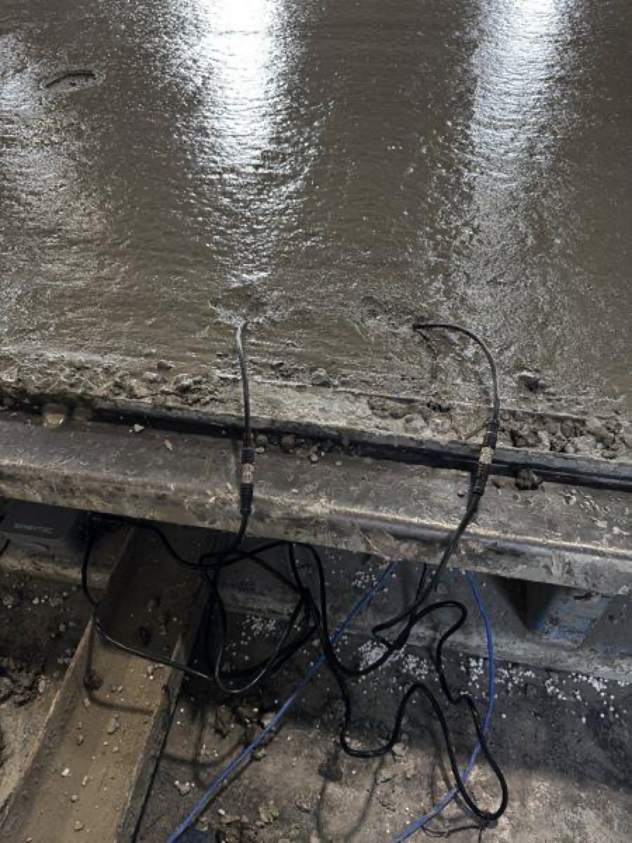 SensyCast probes embedded in concrete beside the legacy system's thermocouple wire on the same bed