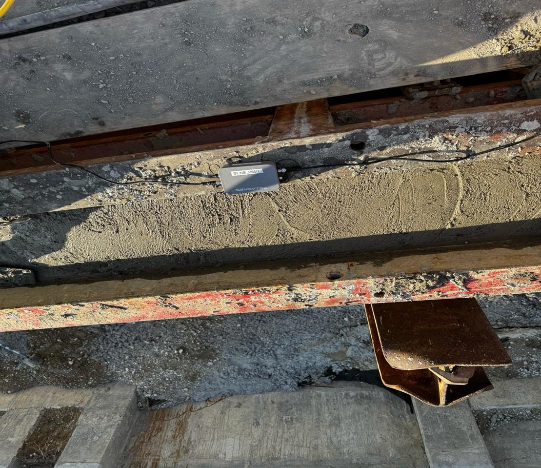 SensyCast wireless logger SENS 0553 mounted on the form rail during the outfall wall pour, cabled to embedded maturity probes