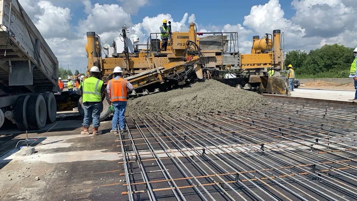 Webber crew pouring concrete on Texas DOT highway with Sensytec sensors monitoring temperature and strength